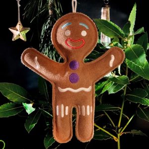 Gingerbread toy hanging in a Christmas tree