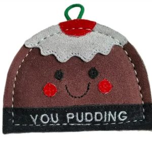 Close up of you pudding toy showing it's smiling face on a white background