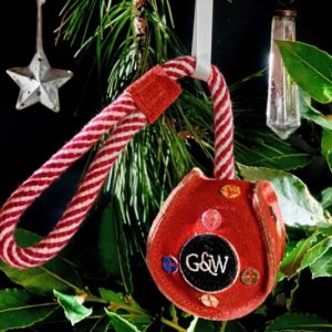 Red bauble toy hanging in a Christmas tree