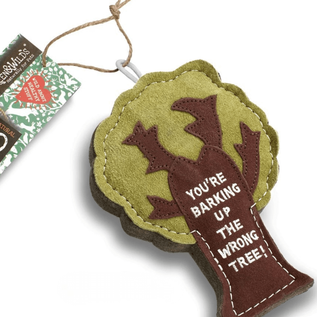 Green & Wild’s eco dog toy shaped like a tree made from natural felt and suede with stitched slogan “You’re Barking Up the Wrong Tree,” shown with product tag.
